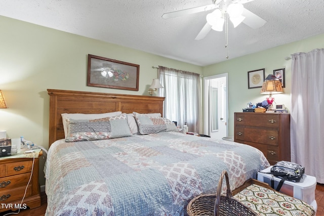 bedroom with ceiling fan and a textured ceiling