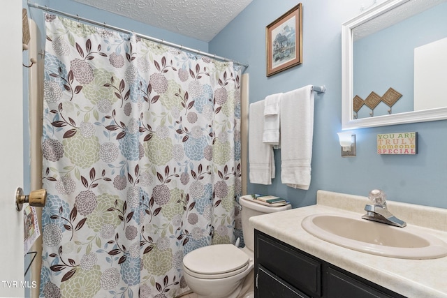 bathroom with walk in shower, vanity, toilet, and a textured ceiling