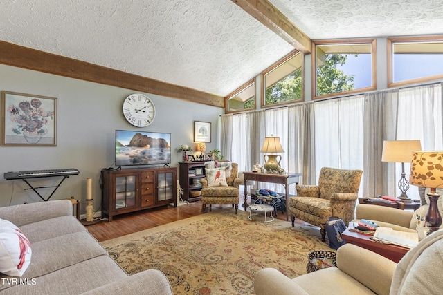 living room featuring vaulted ceiling with beams, a wealth of natural light, and a textured ceiling