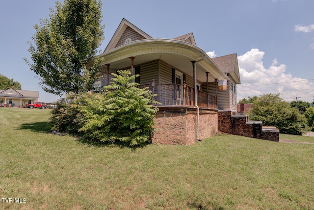 view of side of home with a lawn