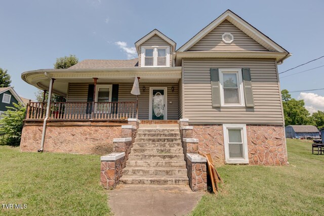 view of front facade featuring a front yard and covered porch