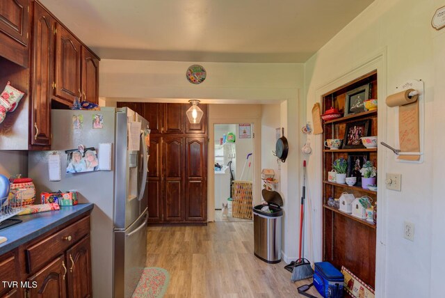 kitchen with stainless steel fridge and light hardwood / wood-style floors