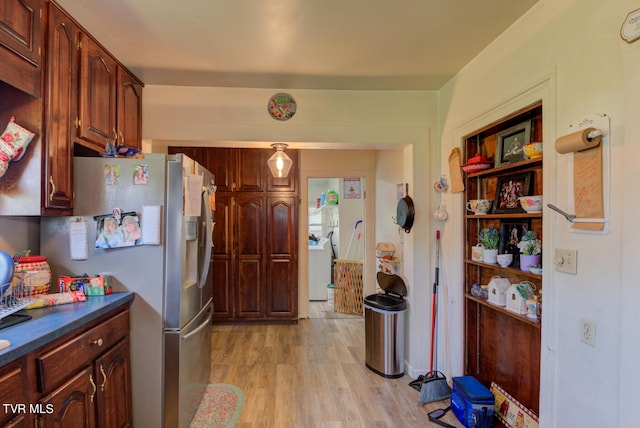 kitchen featuring stainless steel refrigerator and light hardwood / wood-style flooring