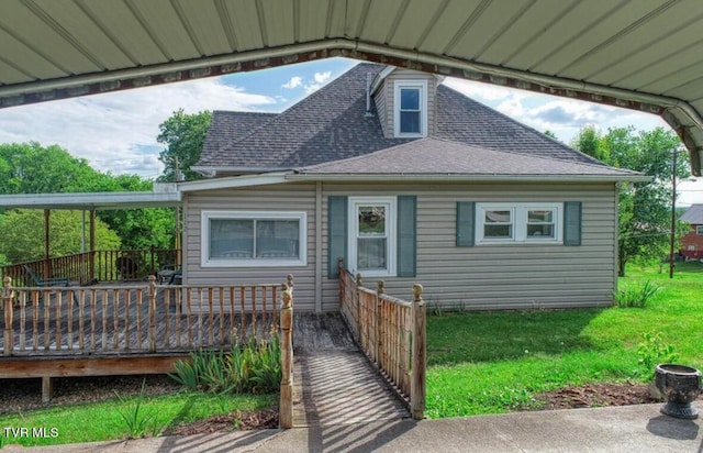 view of front of home featuring a front yard and a deck