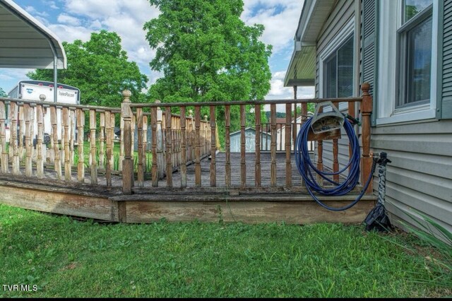 exterior space with a wooden deck and a storage unit