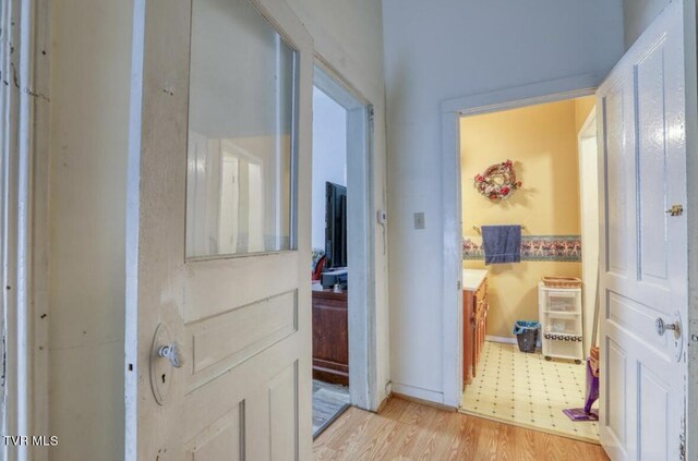 hallway featuring light tile floors