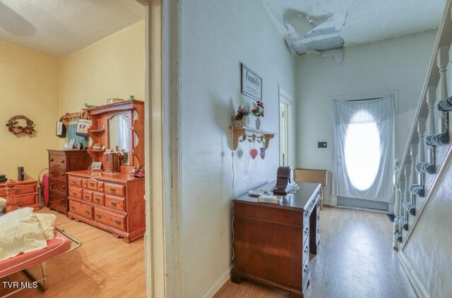 foyer entrance with hardwood / wood-style flooring and a textured ceiling