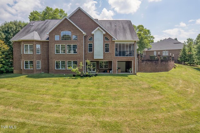 back of house with a lawn