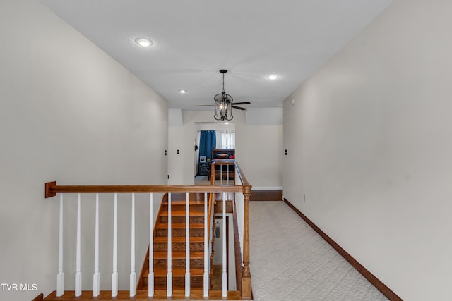 corridor with recessed lighting, stairs, light carpet, and baseboards