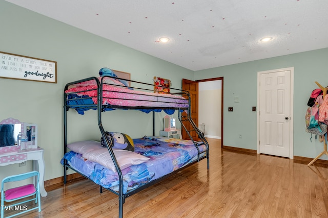 bedroom with recessed lighting, light wood-style flooring, and baseboards