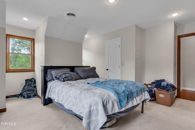 bedroom featuring visible vents, recessed lighting, carpet, and a textured ceiling