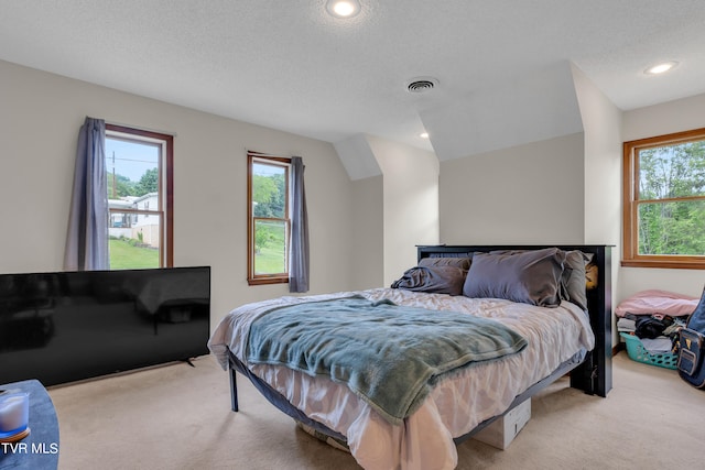 bedroom featuring a textured ceiling, visible vents, recessed lighting, carpet floors, and lofted ceiling