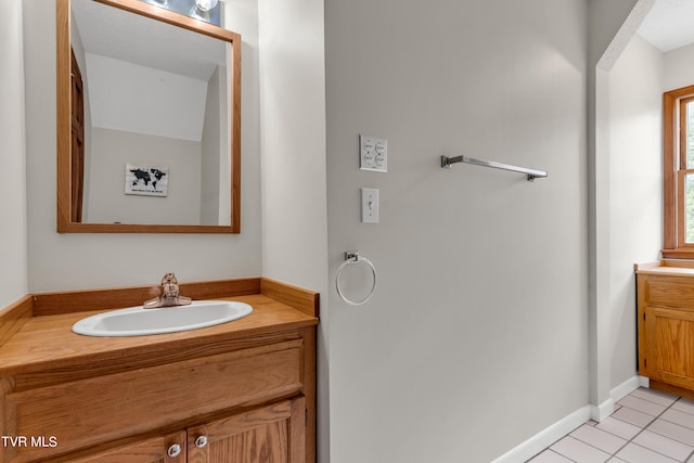 bathroom with tile patterned floors, vanity, and baseboards