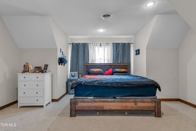 carpeted bedroom featuring a textured ceiling, baseboards, vaulted ceiling, and visible vents