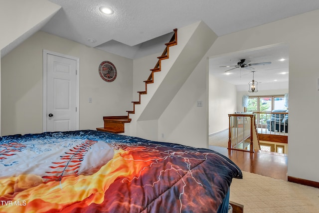 carpeted bedroom featuring baseboards, recessed lighting, and a textured ceiling