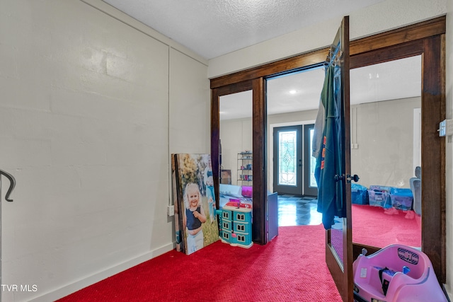 spare room featuring a textured ceiling and carpet floors
