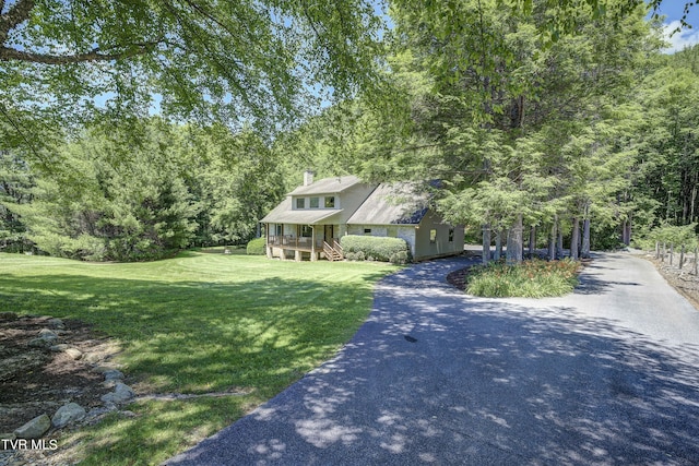 view of front of property featuring a sunroom and a front yard