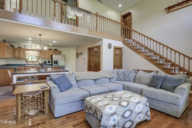 living room featuring sink, light hardwood / wood-style floors, and a notable chandelier