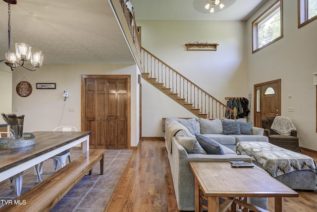 living room with hardwood / wood-style flooring and an inviting chandelier