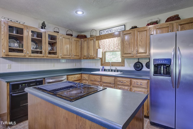 kitchen featuring decorative backsplash, a textured ceiling, sink, black appliances, and a center island