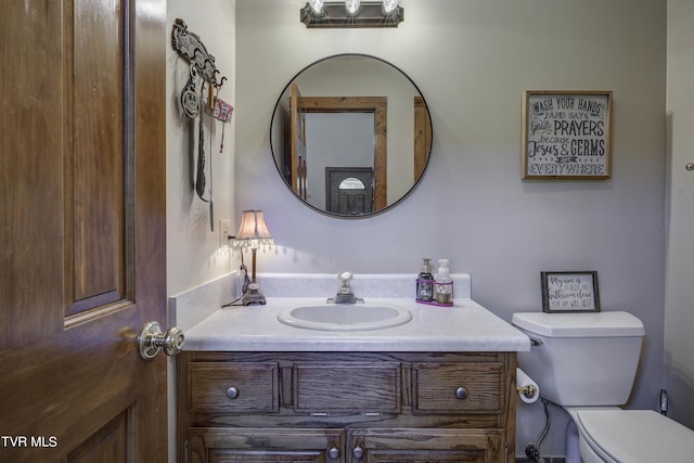 bathroom featuring vanity and toilet