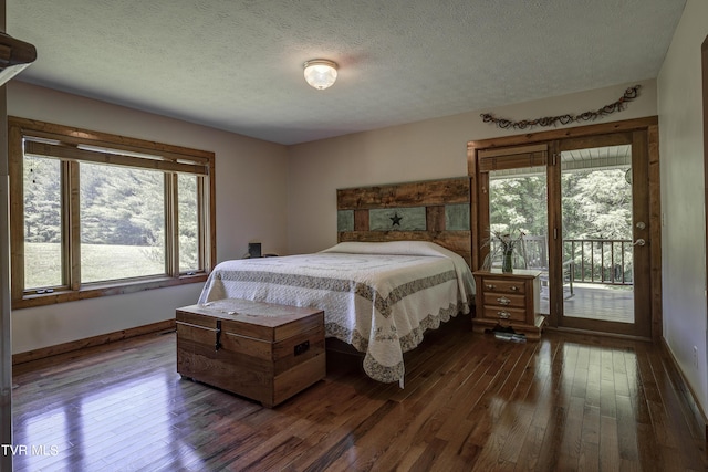 bedroom with dark hardwood / wood-style floors, access to outside, and multiple windows