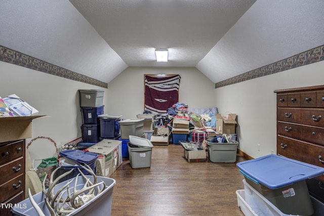 bonus room featuring a textured ceiling, dark hardwood / wood-style flooring, and vaulted ceiling