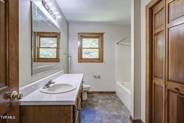 bathroom featuring a textured ceiling, vanity, and toilet