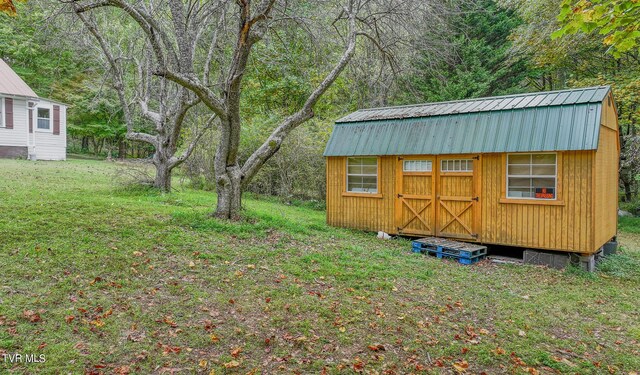 view of outdoor structure featuring a lawn