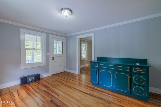 foyer entrance featuring ornamental molding and light hardwood / wood-style flooring