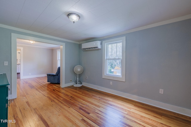 empty room featuring ornamental molding, light hardwood / wood-style flooring, and a wall unit AC