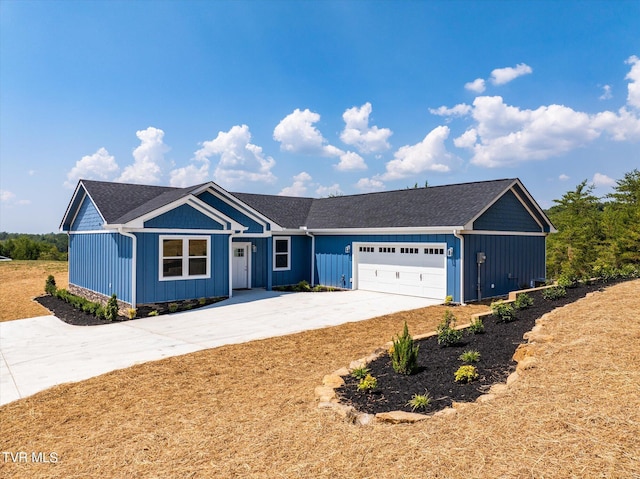 2137 Rainwater Rd, Dandridge, TN 37725 - ranch-style house featuring concrete driveway, an attached garage, and board and batten siding