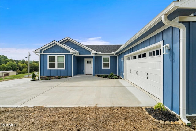 2137 Rainwater Rd, Dandridge, TN 37725 - single story home featuring board and batten siding, concrete driveway, and a garage
