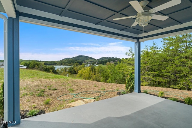 view of patio / terrace with a water view and ceiling fan