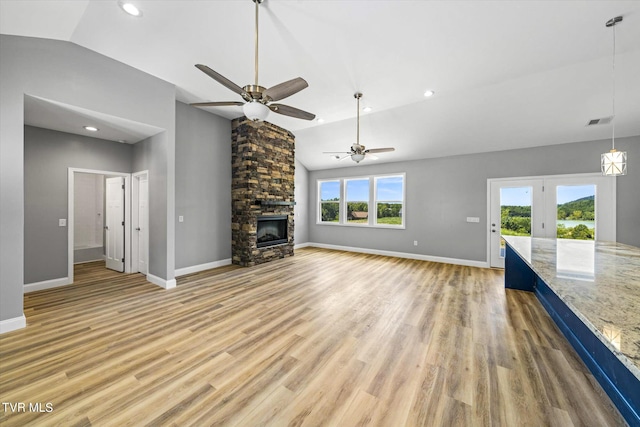 2137 Rainwater Rd, Dandridge, TN 37725 - unfurnished living room with lofted ceiling, a ceiling fan, light wood-style flooring, a fireplace, and baseboards