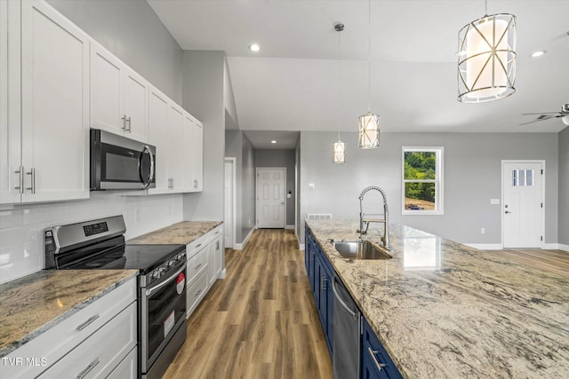 2137 Rainwater Rd, Dandridge, TN 37725 - kitchen featuring appliances with stainless steel finishes, a sink, blue cabinetry, white cabinetry, and wood finished floors