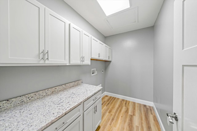 washroom featuring washer hookup, cabinets, light wood-type flooring, and electric dryer hookup