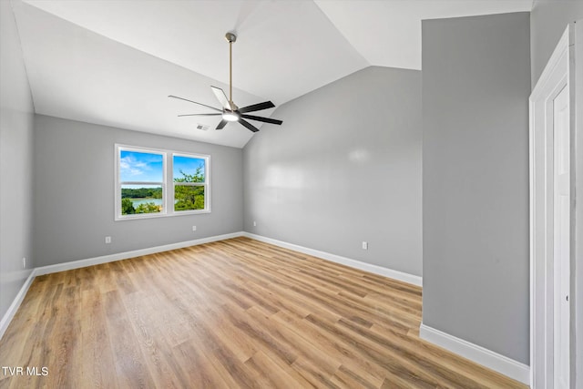 unfurnished room with light hardwood / wood-style floors, vaulted ceiling, and ceiling fan