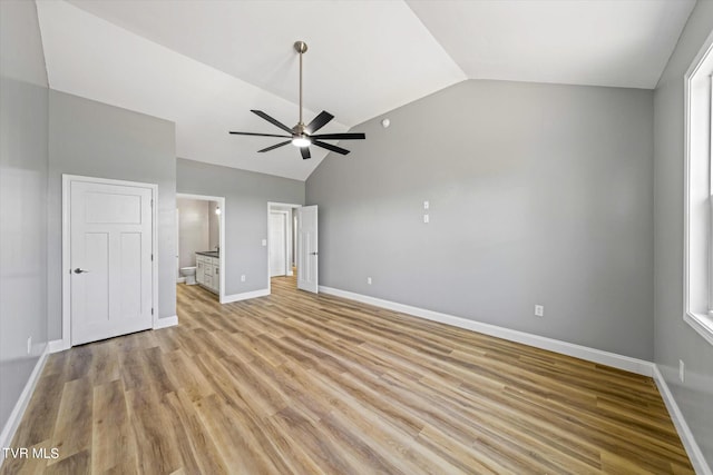 2137 Rainwater Rd, Dandridge, TN 37725 - unfurnished bedroom with vaulted ceiling, ensuite bath, light wood finished floors, baseboards, and ceiling fan