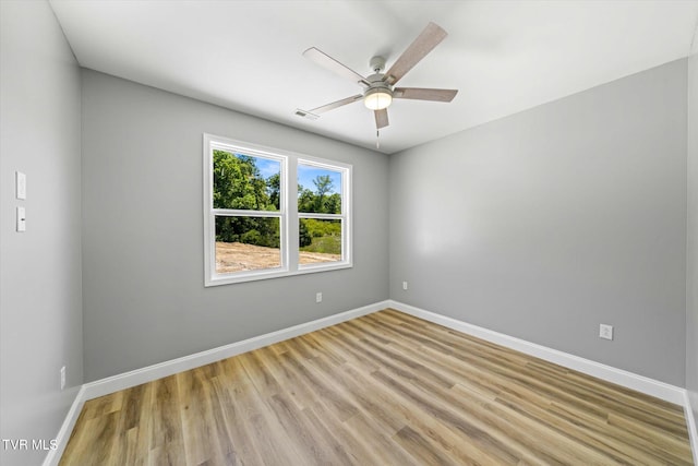 2137 Rainwater Rd, Dandridge, TN 37725 - spare room featuring light wood finished floors, ceiling fan, and baseboards