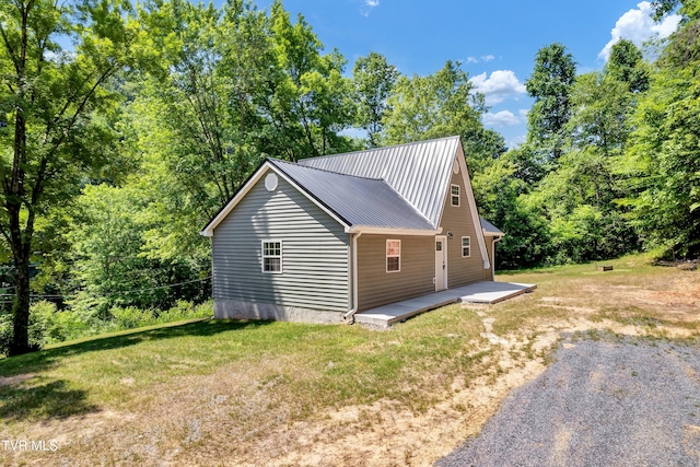 view of side of property with a lawn