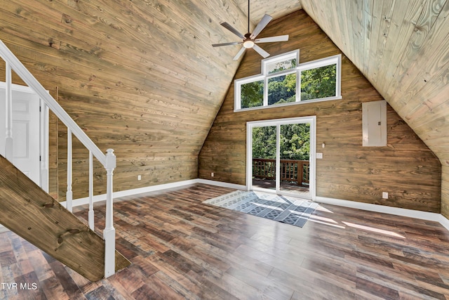 additional living space featuring a towering ceiling, ceiling fan, wooden walls, wood-type flooring, and wooden ceiling