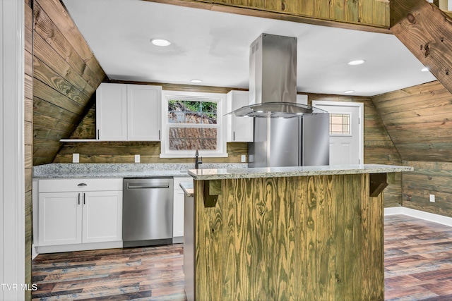 kitchen with light stone countertops, a kitchen island, white cabinetry, and stainless steel dishwasher