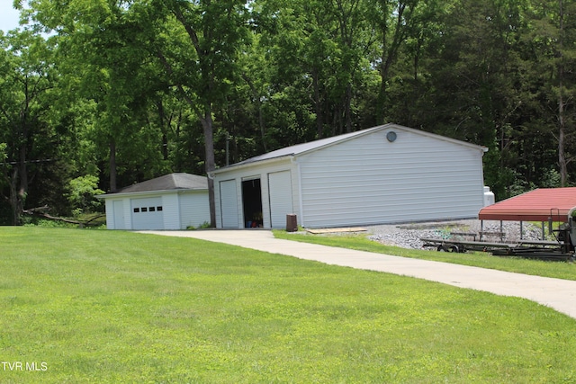 view of outdoor structure with a lawn and a garage