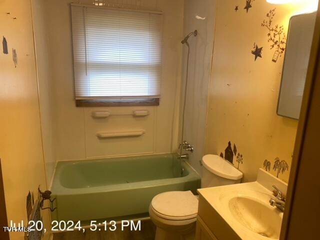 full bathroom featuring bathing tub / shower combination, vanity, and toilet