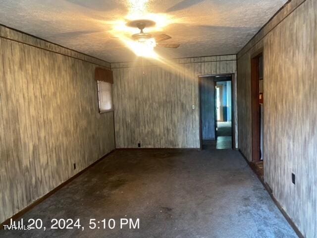 spare room with concrete floors and ceiling fan