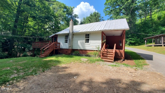 back of house with a lawn