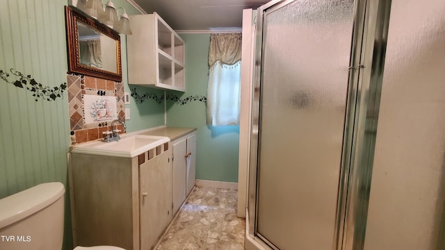 bathroom featuring vanity, a shower with shower door, and toilet