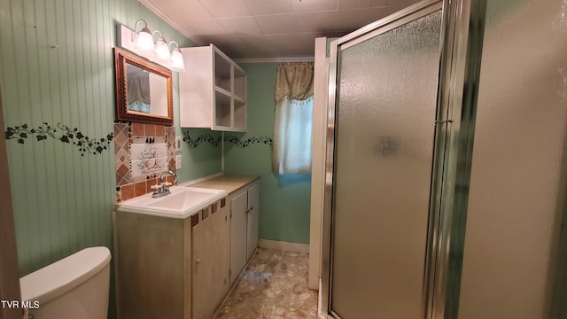 bathroom with vanity, a shower with shower door, ornamental molding, and toilet