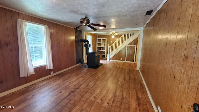 unfurnished room with hardwood / wood-style floors, ornamental molding, and a textured ceiling